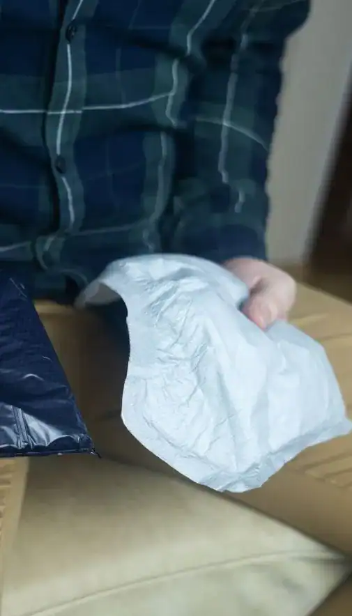 Image of man holding incontinence pads as part of overactive bladder treatment Southampton